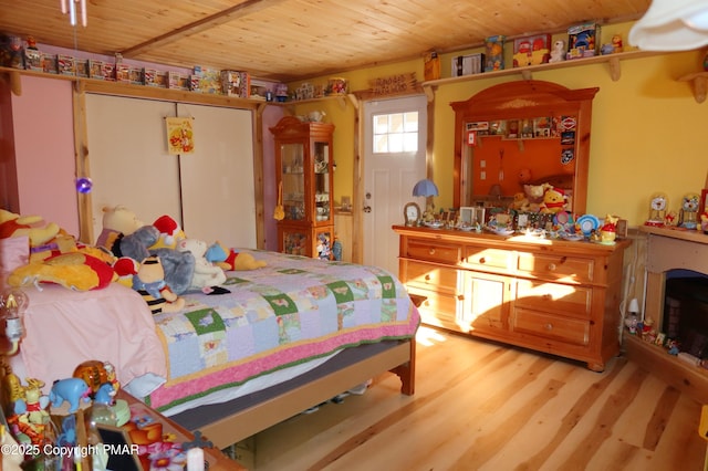 bedroom with wooden ceiling and wood finished floors