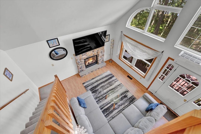 318 N Arrow Dr, Pocono Lake, PA 18347 - living room with wood finished floors, a fireplace, and vaulted ceiling