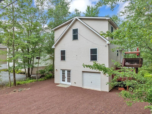 318 N Arrow Dr, Pocono Lake, PA 18347 - back of house featuring french doors, driveway, a garage, and a deck