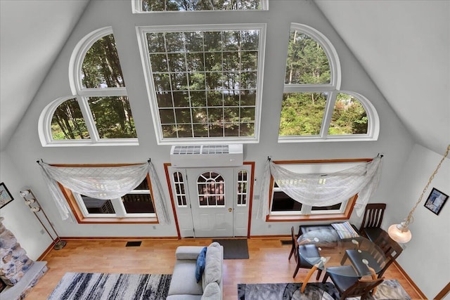 318 N Arrow Dr, Pocono Lake, PA 18347 - living room with healthy amount of natural light, wood finished floors, and high vaulted ceiling