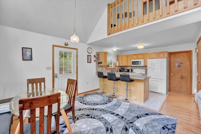 318 N Arrow Dr, Pocono Lake, PA 18347 - dining area featuring light wood-style flooring and high vaulted ceiling