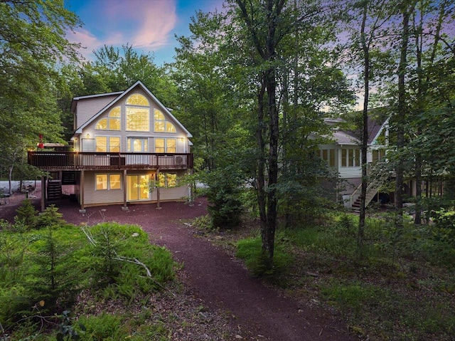 318 N Arrow Dr, Pocono Lake, PA 18347 - back of house at dusk featuring stairs and a deck
