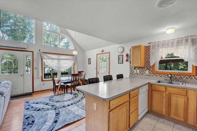 318 N Arrow Dr, Pocono Lake, PA 18347 - kitchen with a wall mounted AC, white dishwasher, decorative backsplash, a peninsula, and vaulted ceiling