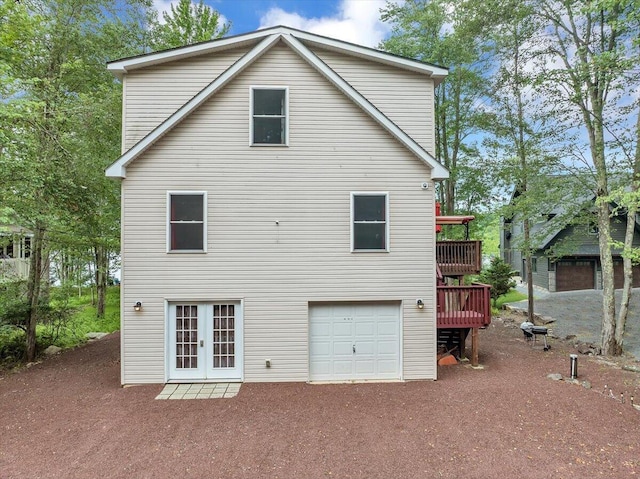 318 N Arrow Dr, Pocono Lake, PA 18347 - rear view of house featuring an attached garage, french doors, driveway, and a wooden deck