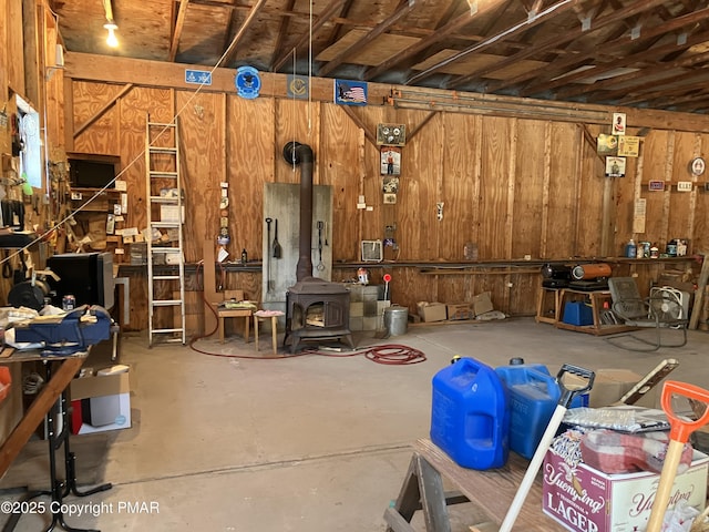 garage featuring a workshop area and wood walls