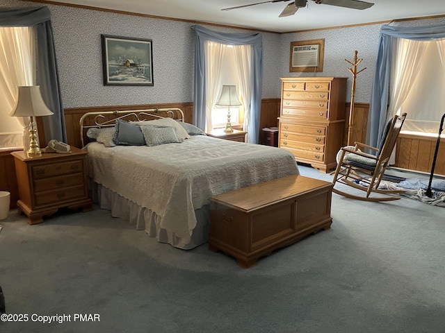 bedroom with wallpapered walls, a wainscoted wall, a wall unit AC, ornamental molding, and carpet flooring