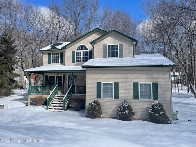 view of front of property with stairway and covered porch