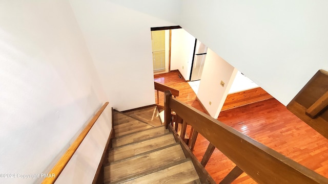 stairway with wood finished floors