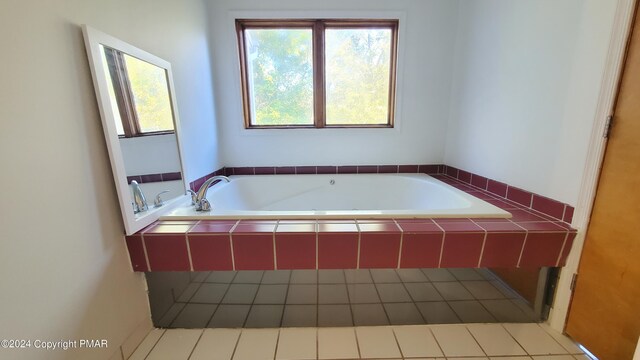 full bathroom with tile patterned floors, a healthy amount of sunlight, and a bath