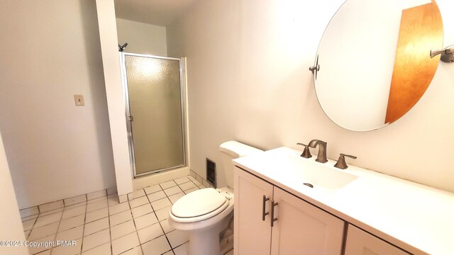 full bath featuring a stall shower, vanity, toilet, and tile patterned floors