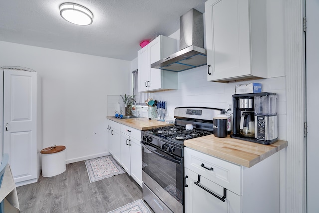 418 Leander Rd, East Stroudsburg, PA 18302 - kitchen featuring gas range, wall chimney range hood, light wood-style floors, decorative backsplash, and wood counters