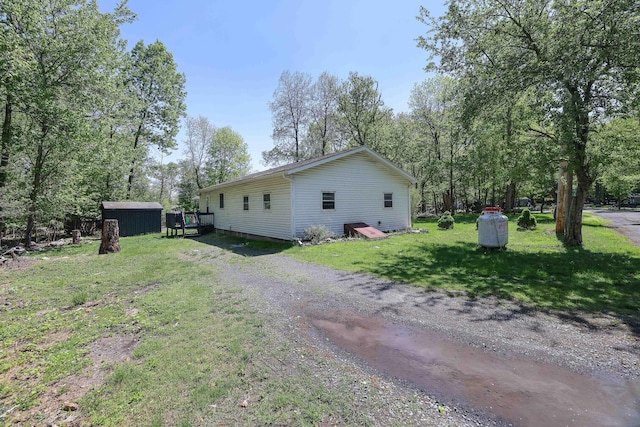 418 Leander Rd, East Stroudsburg, PA 18302 - view of side of property with a lawn, a storage unit, and an outdoor structure
