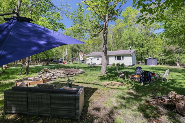 418 Leander Rd, East Stroudsburg, PA 18302 - view of green lawn with an outdoor living space with a fire pit, a storage unit, and an outdoor structure