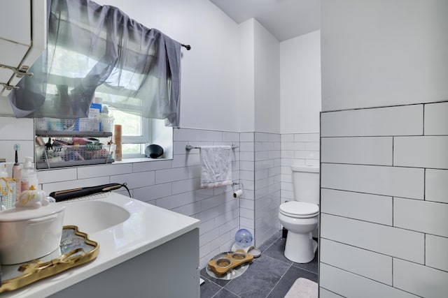 418 Leander Rd, East Stroudsburg, PA 18302 - bathroom with tile walls, toilet, tile patterned floors, vanity, and wainscoting