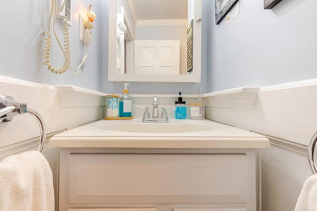 bathroom with crown molding and vanity