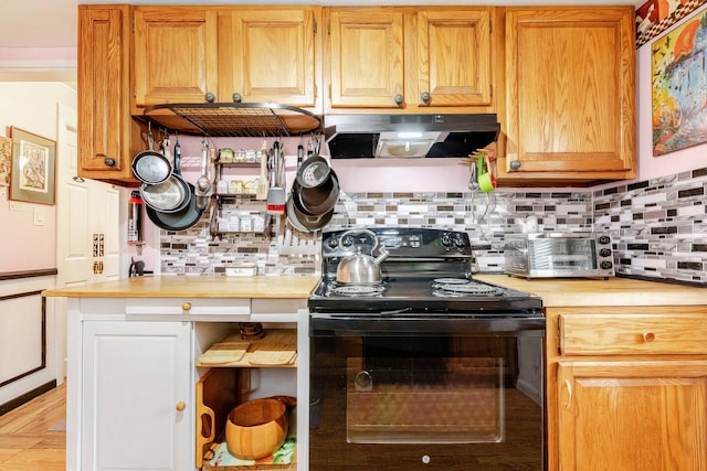 kitchen with black electric range, under cabinet range hood, tasteful backsplash, and light countertops