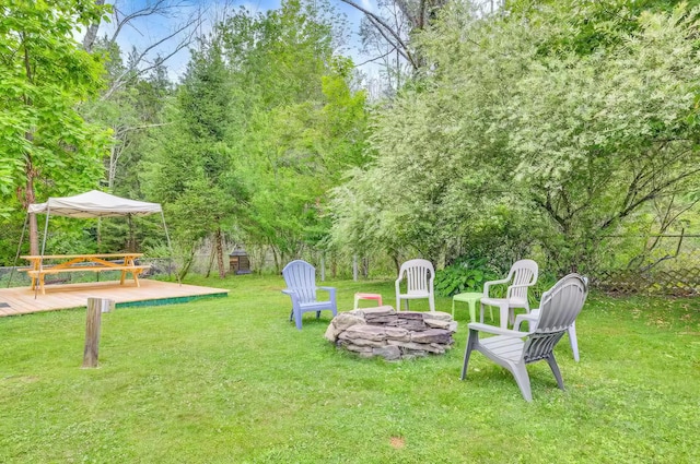 view of yard featuring an outdoor fire pit and a deck