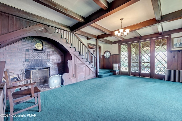 117 Stonecrop Ln, Mount Pocono, PA 18344 - living room with carpet, beam ceiling, a chandelier, stairs, and brick wall