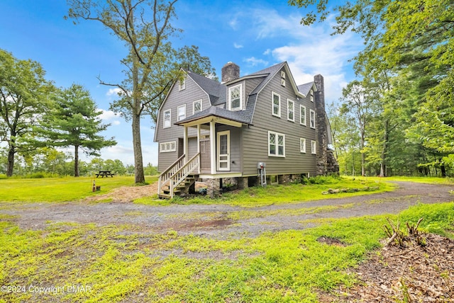 view of front facade featuring a front yard and a chimney