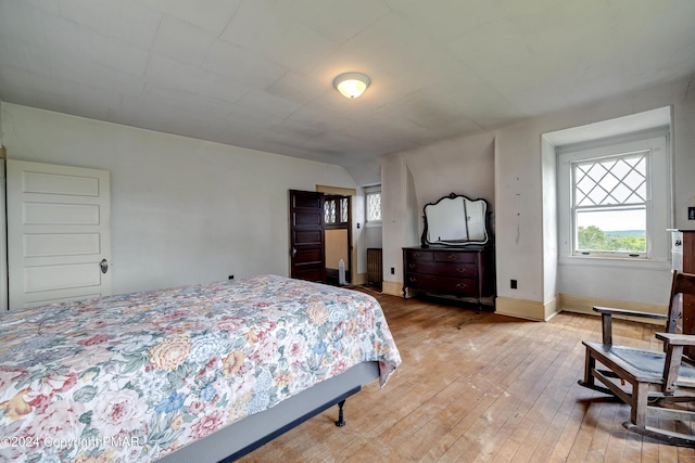 bedroom with light wood-style flooring and baseboards