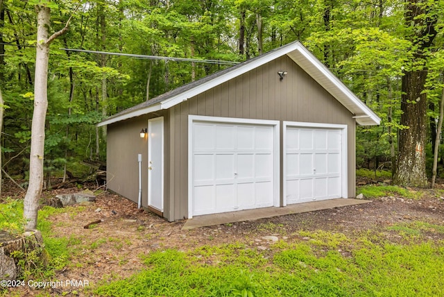 detached garage with a wooded view