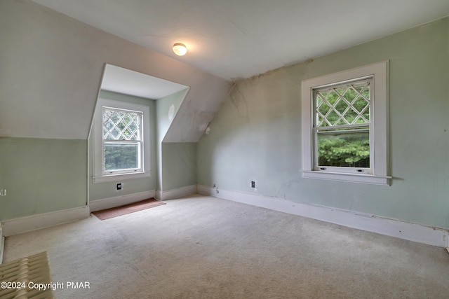 additional living space featuring vaulted ceiling, carpet flooring, and baseboards