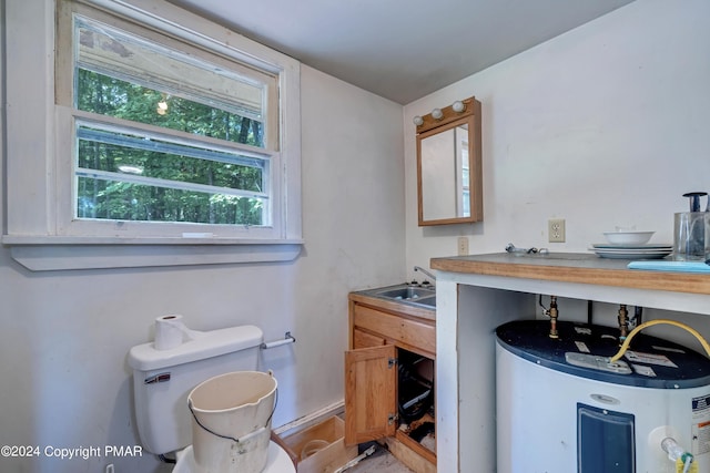 bathroom with a sink, toilet, and electric water heater