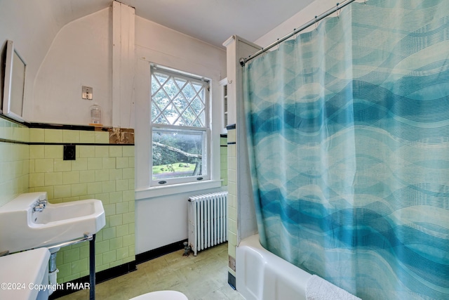 bathroom with shower / tub combo, tile walls, and radiator heating unit