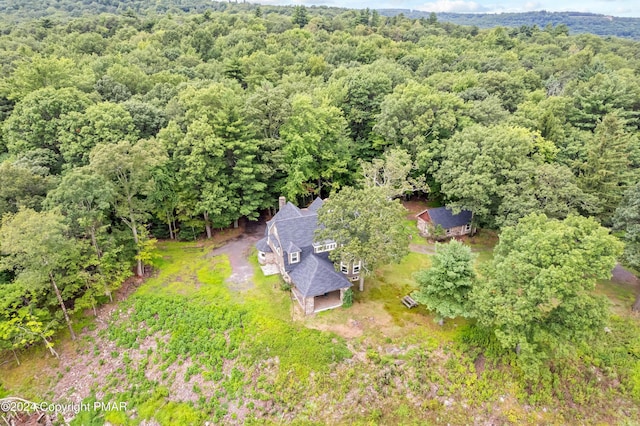 drone / aerial view featuring a forest view