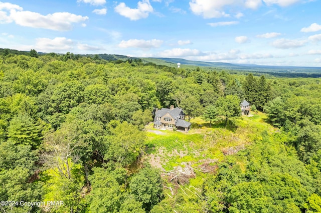 drone / aerial view with a wooded view