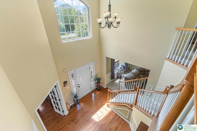 140 Birdie Way, Kunkletown, PA 18058 - foyer entrance with a chandelier, a towering ceiling, wood finished floors, and baseboards