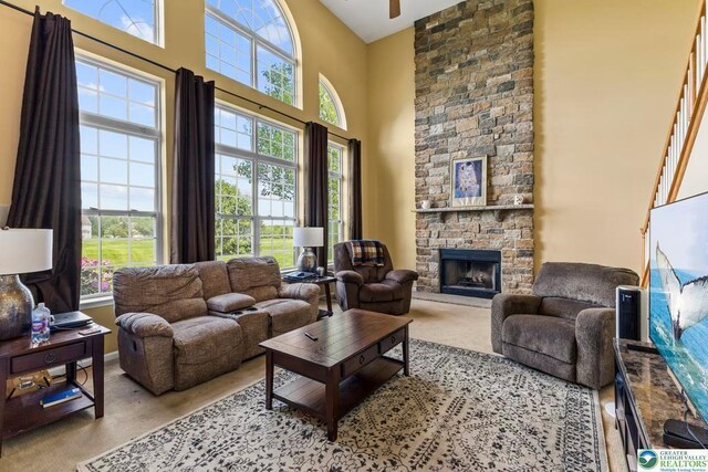 140 Birdie Way, Kunkletown, PA 18058 - carpeted living area with a towering ceiling, healthy amount of natural light, a fireplace, baseboards, and ceiling fan