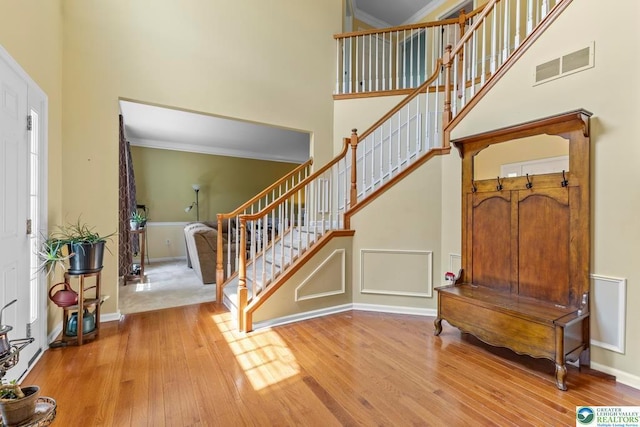 140 Birdie Way, Kunkletown, PA 18058 - entryway featuring hardwood / wood-style floors, a high ceiling, stairs, baseboards, and crown molding