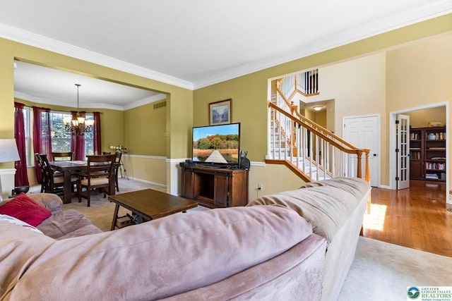 140 Birdie Way, Kunkletown, PA 18058 - living room with a chandelier, stairs, crown molding, carpet flooring, and wood finished floors