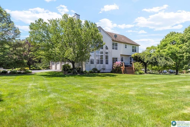 140 Birdie Way, Kunkletown, PA 18058 - rear view of house featuring a yard, a garage, and a chimney
