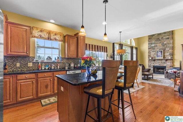 140 Birdie Way, Kunkletown, PA 18058 - kitchen with light wood-type flooring, a sink, backsplash, a kitchen island, and brown cabinets