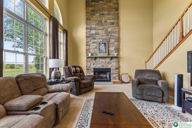 140 Birdie Way, Kunkletown, PA 18058 - living room with a high ceiling, a fireplace, stairs, and light colored carpet