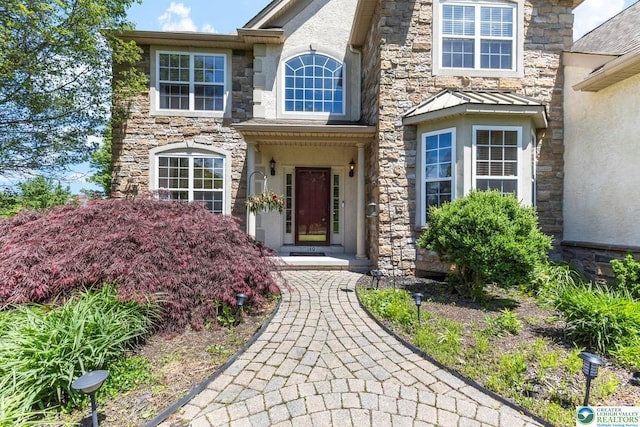 140 Birdie Way, Kunkletown, PA 18058 - view of exterior entry with stone siding, stucco siding, and a standing seam roof