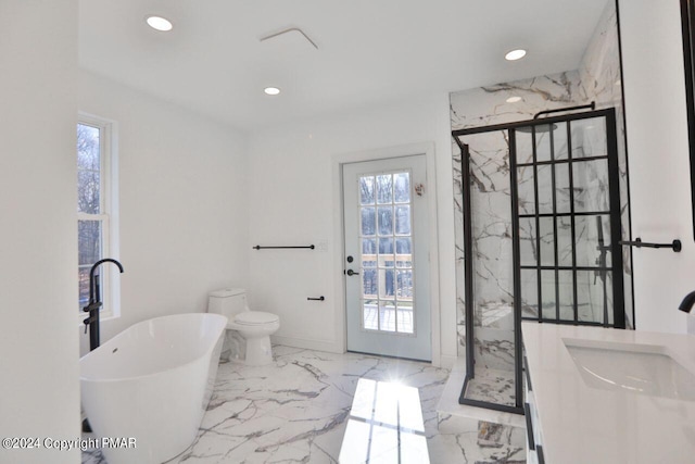 full bathroom featuring marble finish floor, a freestanding tub, a marble finish shower, and a healthy amount of sunlight