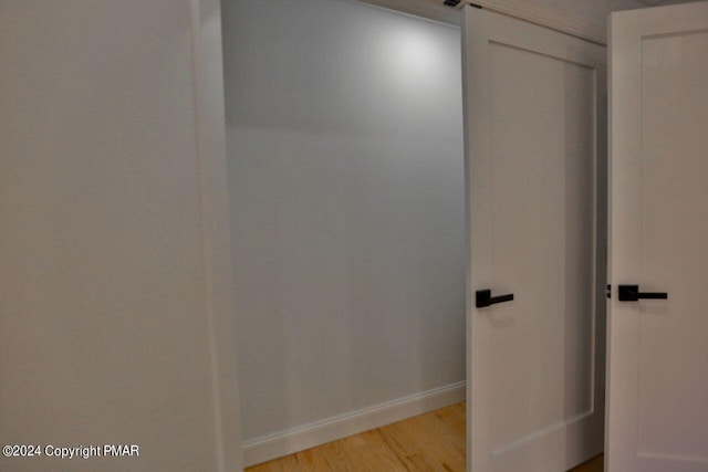 bathroom featuring wood finished floors and baseboards