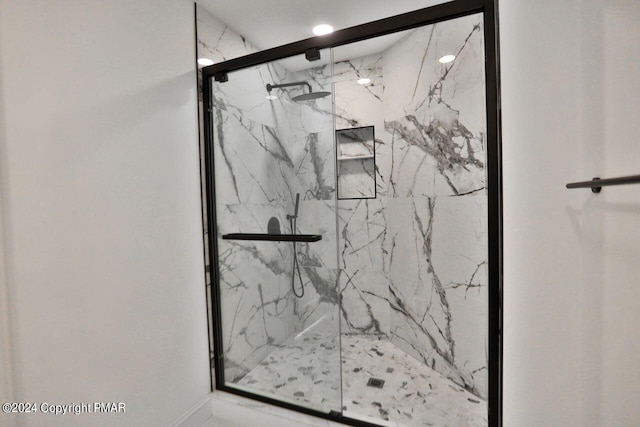 bathroom with a marble finish shower