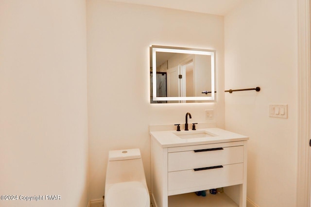 bathroom with vanity and toilet