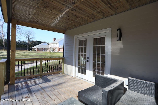 deck featuring french doors and a lawn