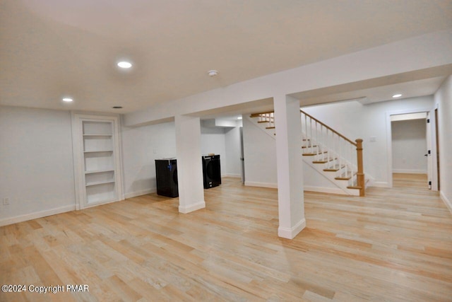 finished basement with light wood-style floors, stairs, baseboards, and recessed lighting