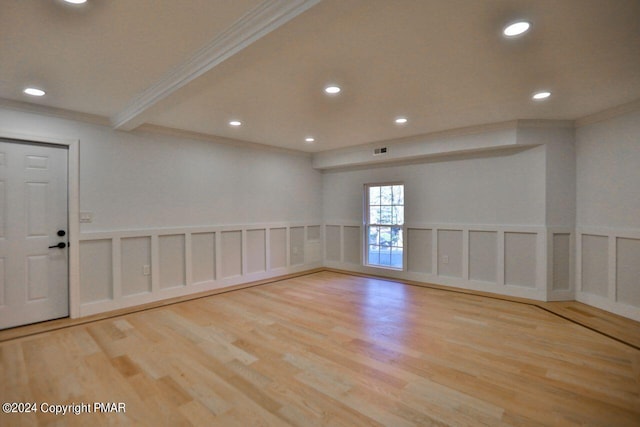 unfurnished room featuring recessed lighting, a decorative wall, and wood finished floors