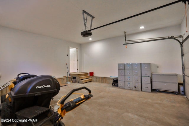 garage with recessed lighting and a garage door opener