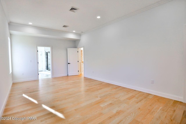 spare room featuring baseboards, ornamental molding, recessed lighting, and light wood-style floors