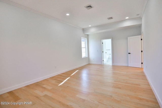 unfurnished room with crown molding, recessed lighting, visible vents, light wood-type flooring, and baseboards