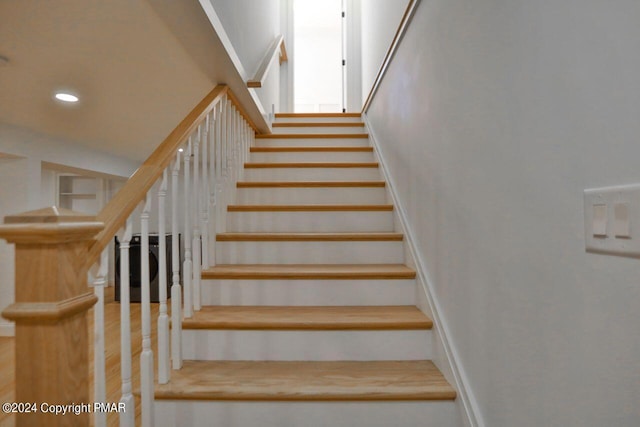 staircase featuring recessed lighting