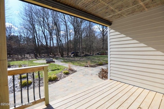 wooden deck featuring a yard